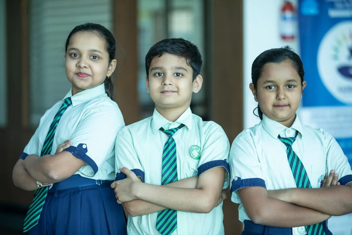 Three schoolchildren in Bengaluru, India, representing confidence and friendship